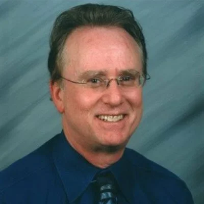 A man with glasses and a blue shirt