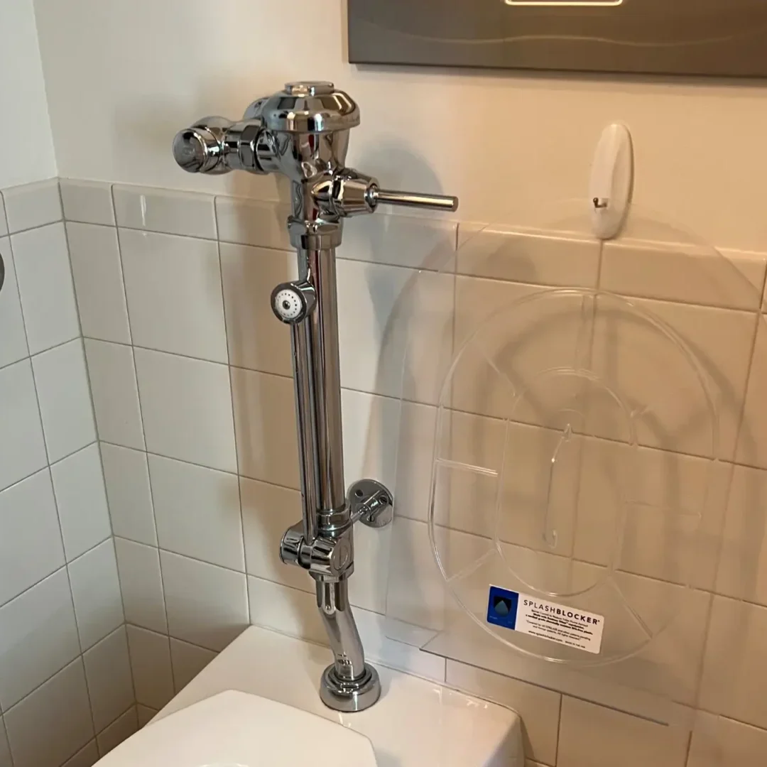 A toilet with the seat up and a faucet on it.